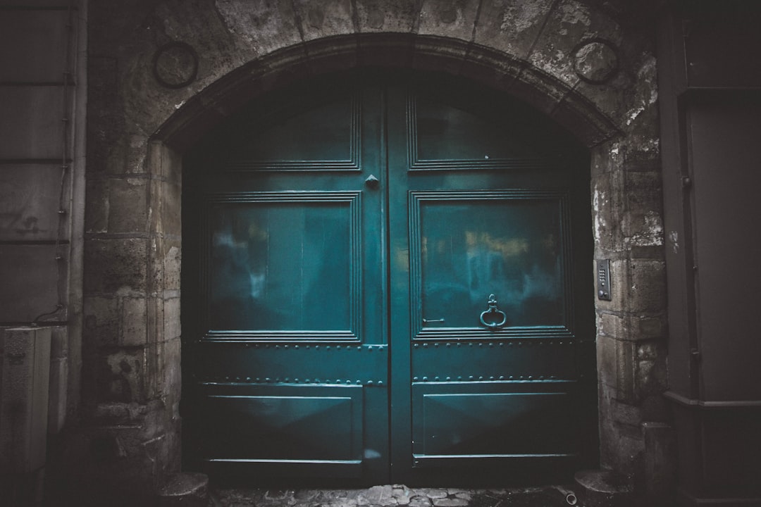 blue wooden double arch door s, A teal door in Paris