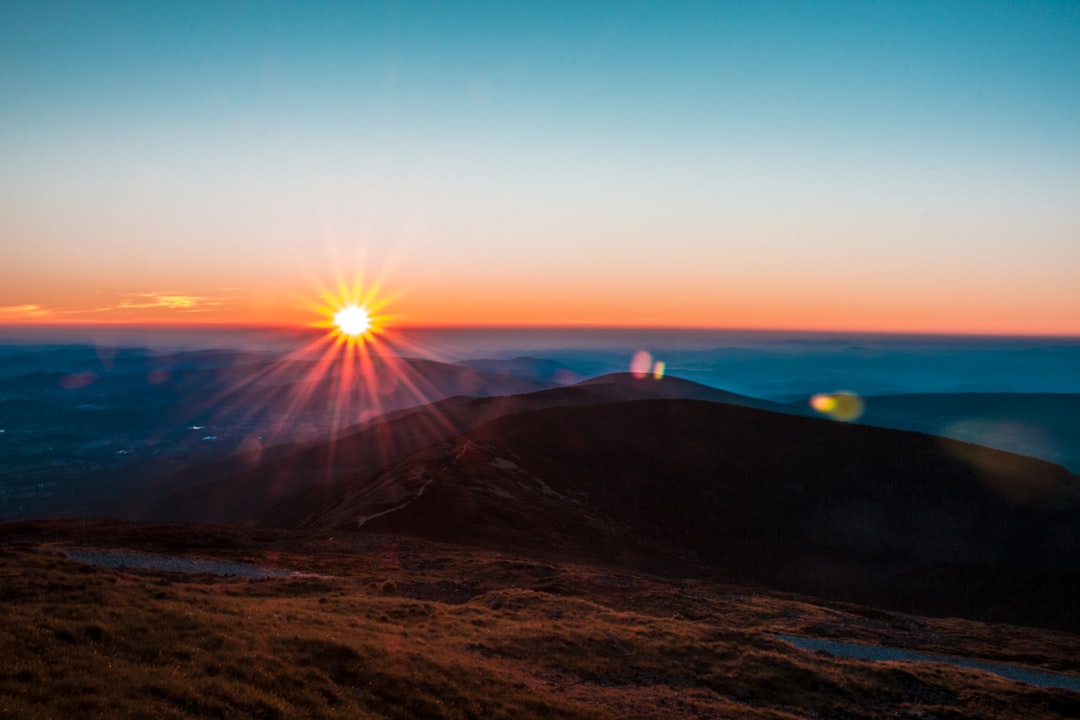 silhouette photography of mountain during golden hour, Sněžka sunrays on a mountain