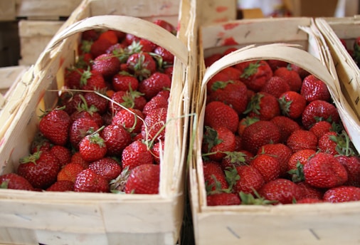 A delivery basket filled with fresh strawberries.