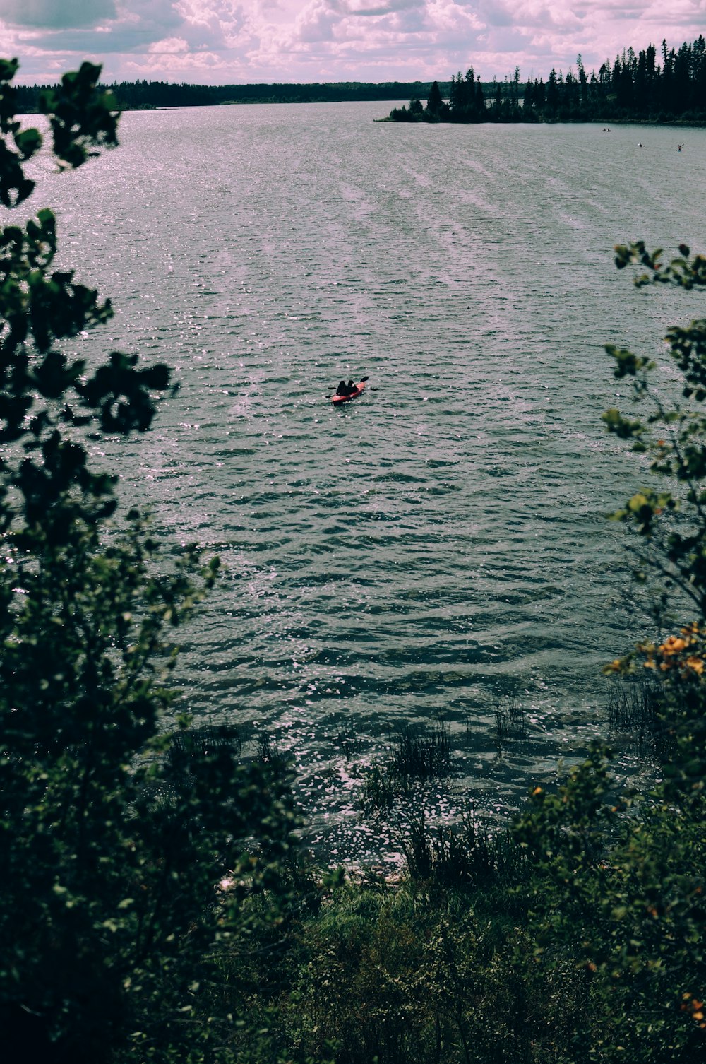 body of water under cloudy sky