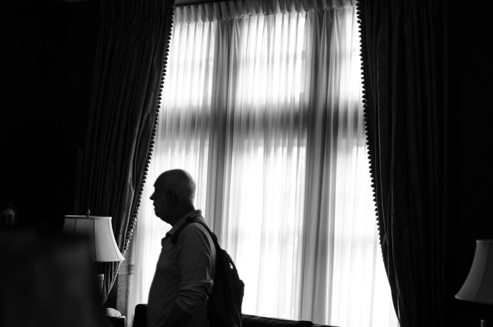 man standing near window