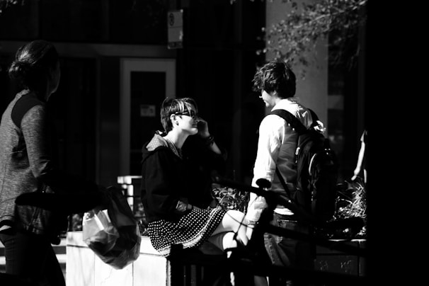 A candid street photograph showing spontaneous moments and human connection.