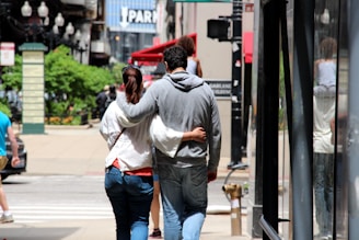A couple exploring a vibrant city street together.