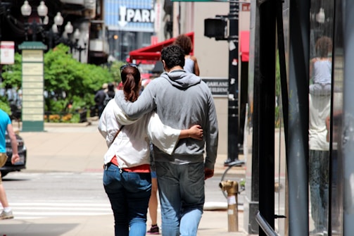 A couple exploring a vibrant city street together.