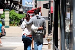 Couple exploring a vibrant cityscape during their trip planned by Carleone Neres