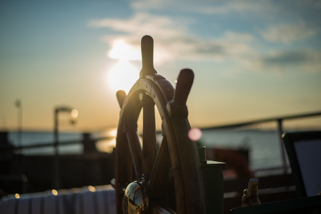 A ship's wheel is seen in Faaborg during sunset.
