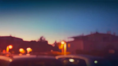 Subtle dimmed image of Orlando downtown skyline at dusk, overlaid with a soft blue tint.