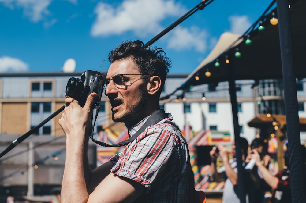 man taking a picture with DSLR camera