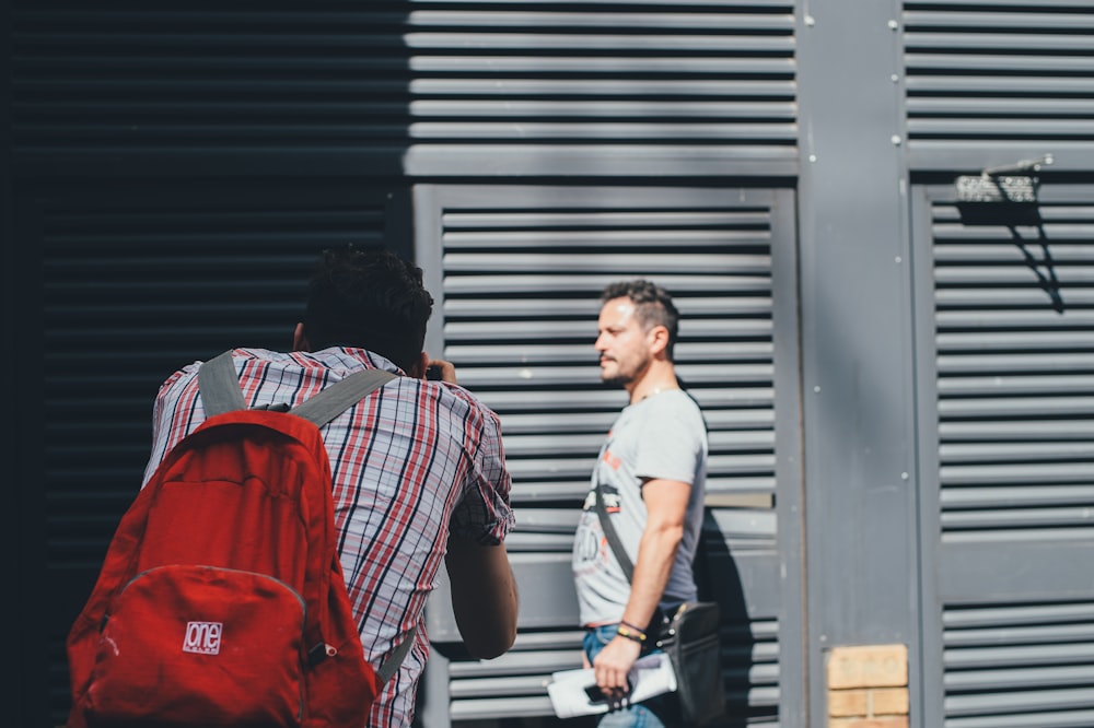 man taking photo of man