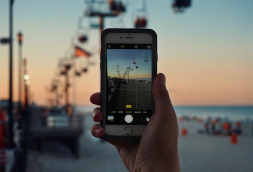A content creator filming a family day out at a theme park, capturing joyful moments.