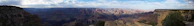 A panoramic view of the Grand Canyon of Yellowstone with its dramatic cliffs and cascading waterfall.