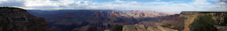 A panoramic view of the Grand Canyon of Yellowstone with its dramatic cliffs and cascading waterfall.