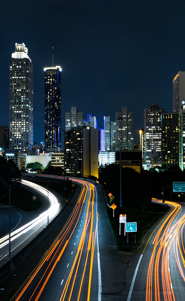 time lapse photo of passing cars during night time