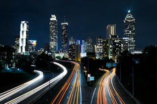 time lapse photo of passing cars during night time
