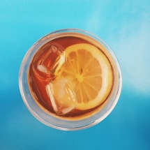 A vibrant, colorful image of refreshing soft drinks with ice cubes and citrus slices.