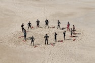 people standing forming a circle during daytime