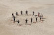 people standing forming a circle during daytime
