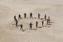 people standing forming a circle during daytime