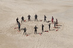 people standing forming a circle during daytime