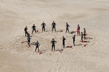 people standing forming a circle during daytime