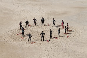 people standing forming a circle during daytime