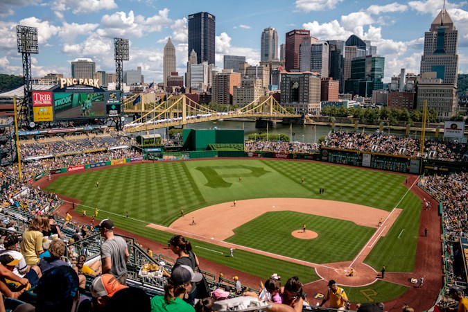 Fans filling the stands to watch a baseball game at an outdoor ballpark