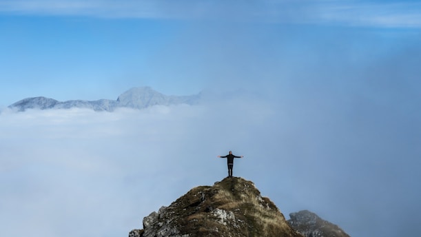 person standing on rock formation during daytime
