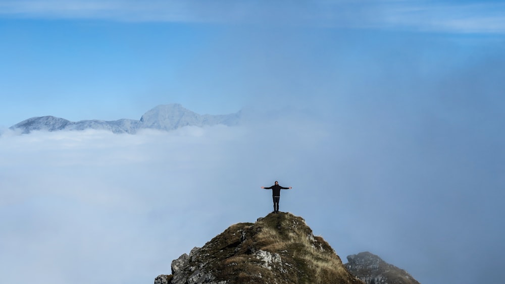 person standing on rock formation during daytime