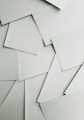 Scattered sheets of white paper covering the entire frame