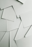 Scattered sheets of white paper covering the entire frame