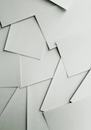 Scattered sheets of white paper covering the entire frame