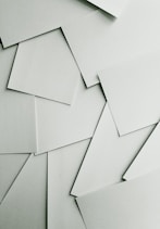 Scattered sheets of white paper covering the entire frame