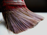 Close-up of flammasilk brush bristles coated with rich barbecue sauce.