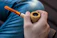 Close-up of a hand holding the Sweet Puff pipe against a dark, reflective surface.
