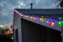 selective focus photography of string lights on roof top edge