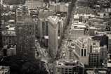 Aerial drone photograph displaying a geometric cityscape in monochrome tones.