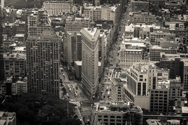 Aerial drone photograph displaying a geometric cityscape in monochrome tones.
