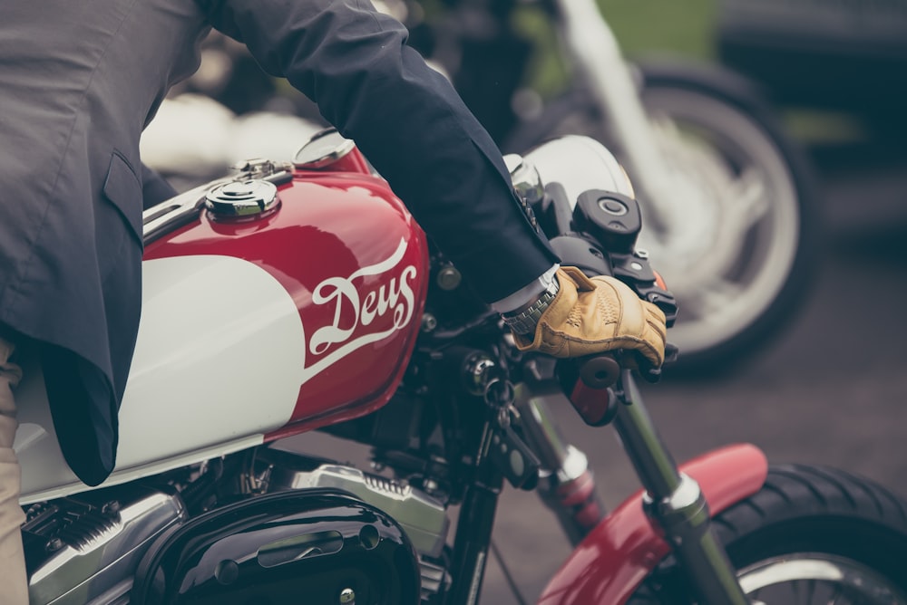 person riding red and gray motorcycle