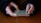 Close-up of hands interacting with a smartphone displaying a mobile game interface.