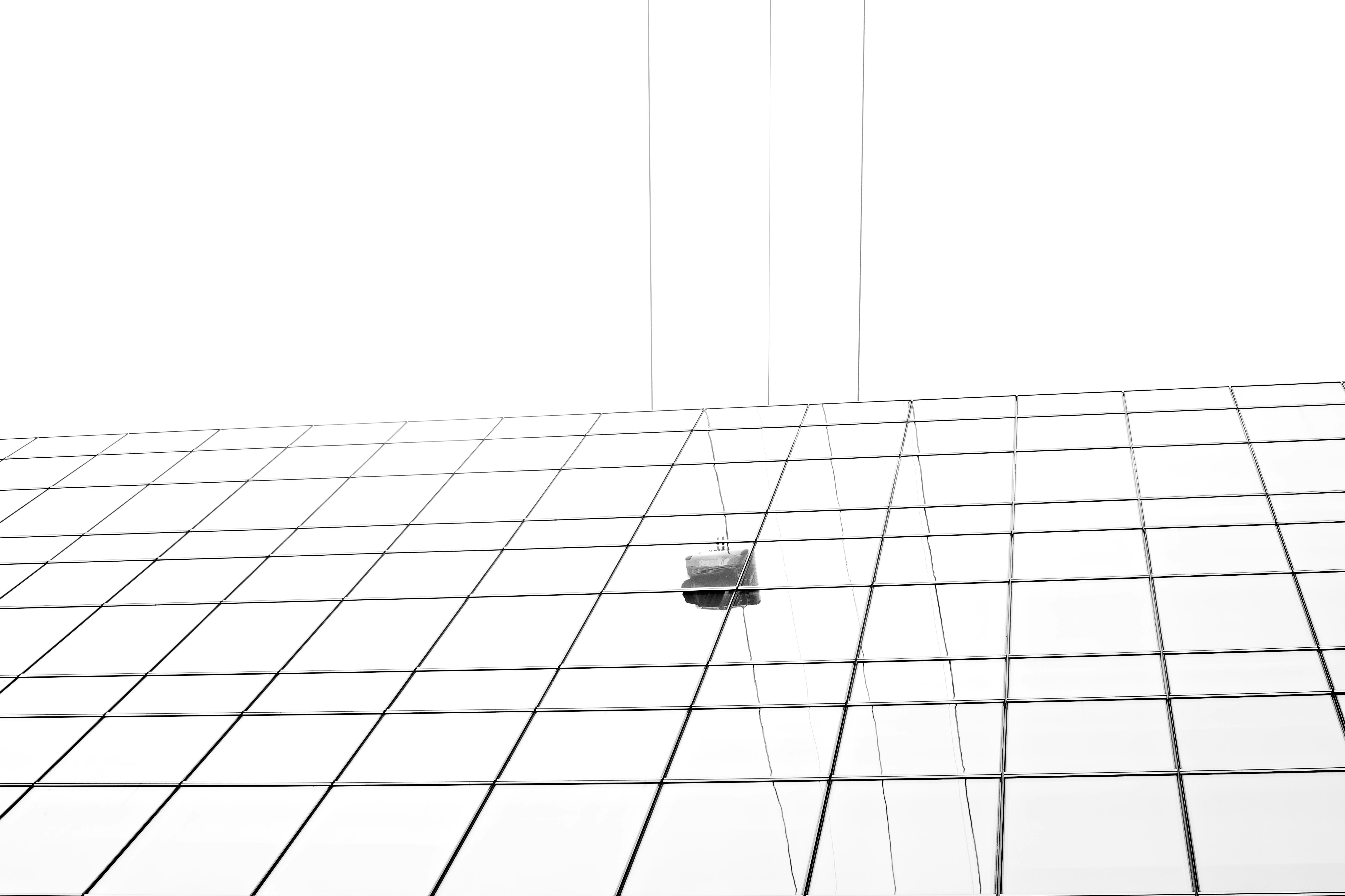 Contemporary art installation with a cell phone hanging from a wire