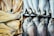 An assortment of dried and fresh fish is displayed. On the left side, there are flat, dried fish fillets, golden and slightly textured. On the right, whole fish with silver scales and eyes are neatly arranged in rows.