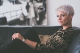 woman sitting on sofa holding eyeglasses