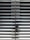 A metallic or aluminum louvered door with horizontal slats and a silver handle on one side. The door is symmetrical and provides a sleek, industrial aesthetic.