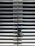 A metallic or aluminum louvered door with horizontal slats and a silver handle on one side. The door is symmetrical and provides a sleek, industrial aesthetic.