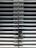 A metallic or aluminum louvered door with horizontal slats and a silver handle on one side. The door is symmetrical and provides a sleek, industrial aesthetic.