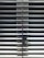 A metallic or aluminum louvered door with horizontal slats and a silver handle on one side. The door is symmetrical and provides a sleek, industrial aesthetic.