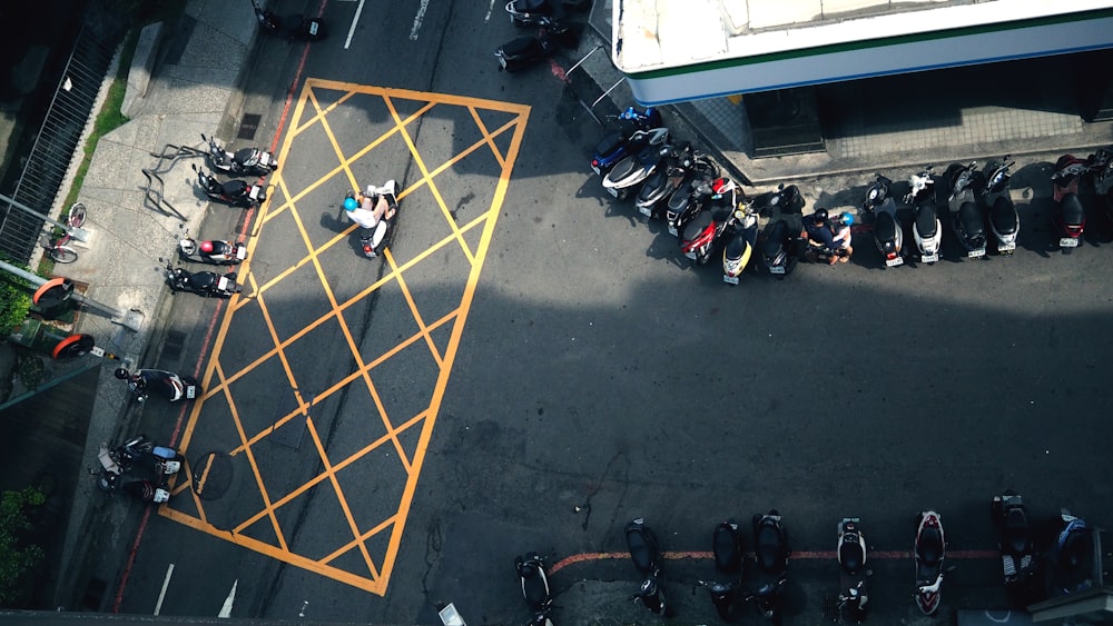 assorted motorcycles parked between road section