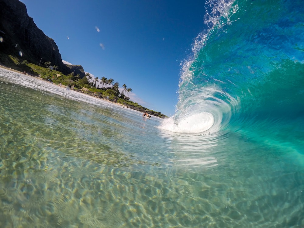 A transparent wave coming in near the shore.