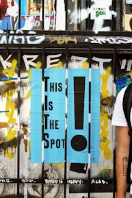 A wooden fence painted with the words "This Is The Spot!"