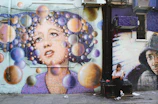 A vibrant street mural depicting a mobile phone symbolizing digital resistance.